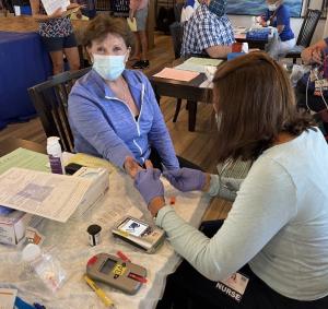 Beebe Healthcare Nurse Cecilia D’Orazio screens resident Madonna Aldrich for any of five chronic conditions.