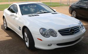 Lovely 2006 Mercedes Benz SL hardtop convertible, white with a panoramic roof and just 75,000 miles on the odometer (estimate: $15,000-$20,000).