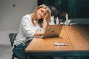 A tired woman using laptop