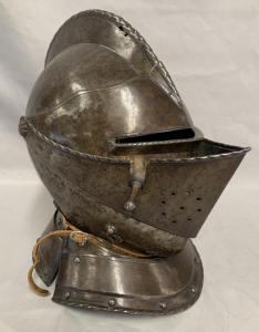 Circa 1570 close helmet – approximately 14 inches tall and almost certainly English, possibly attributed to an Earl ($9,300).