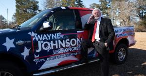 Wayne Johnson Standing with his Campaign Truck