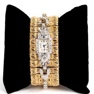 Vintage textured wide 14kt yellow gold bracelet with an attached diamond watch (estimate: $2,000-$4,000).