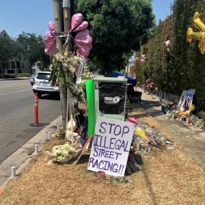 Flowers, signs and candles mark the location where three innocent victims: 21-year-old Cerain Baker, 20-year-old Jaiden Johnson, and 19-year-old Natalee Moghaddam were killed by a speeding driver practicing illegal street racing.  A large handmade sign de