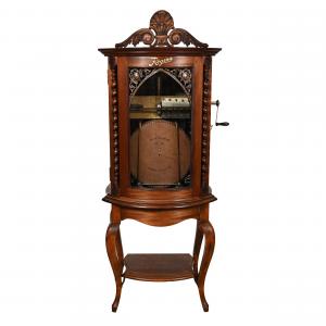 Regina upright music box, serial #3500107, fully operational with good sound, 22 15-inch discs, a mahogany case, curved glass and the original Regina label.