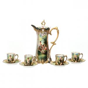R.S. Prussia chocolate set (pot and 6 saucers), with ribbon and jewel mold, a dice throwers scenic décor and dazzling gold and opal jewel highlights.