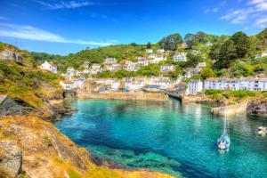 Polperro harbour Cornwall England with clear blue and turquoise sea in vivid colour