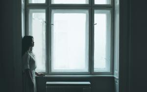 Woman standing by window