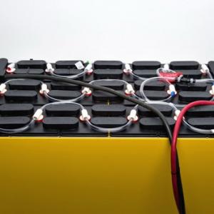 overhead photo of the top of a battery with a water injector on it