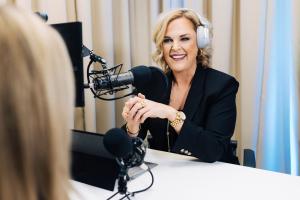 Erin Joy has a lively discussion with a guest.