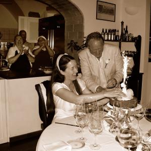 A sepia toned image of Will and Susan having cake and champagne.
