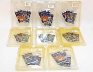 One lot consisting of eight factory-sealed 1999 Pokémon Base Unlimited Booster Pack cards in three-pack clamshells, for a total of 24 packs ($8,438).