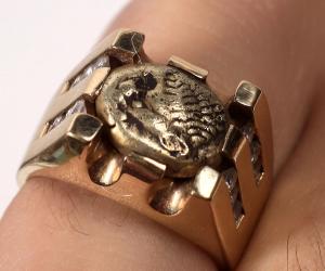 Men’s ring of one troy ounce of solid 14kt gold carefully holding a 1/3 Stater gold coin from the 6th century BC ($3,250).