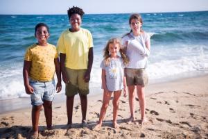 Group of children of different ethnicities are happy together on the beach