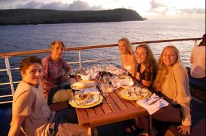 Teens having dinner on a Galapagos family cruise