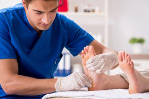 A podiatrist treats feet during a procedure.