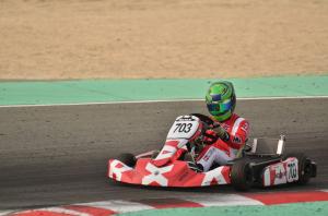 boy in racing go kart on track