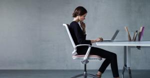 Woman working from home alone. Feeling disconnected and invisible versus her colleagues working in the office. This induces stress.