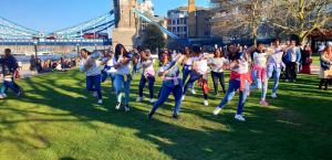 Participants Dancing to glorify Holi at at the Tower Bridge of London