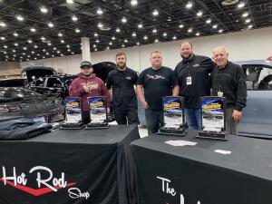 The Hot Rod Shop Staff standing behind their display table at Detroit Autorama 2022