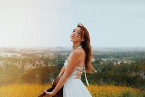 Photo of Emilia Vaughn standing in a flower field. Photograph By: Dani Thompson