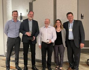 five people holding project awards