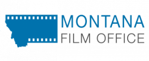 Montana Film Office Logo of a blue state of Montana with film slot patterns across the top and bottom as if the state is a roll of film. The words Montana in all caps blue letters are above Film Office in smaller gray all caps letters next to the shape of