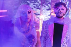 Alyssa Suede in a pink wig and pink bespoke bubble wrap dress with Spaceship in a pink mask and bespoke tinfoil suit on set filming "Let's Get Together"