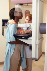 Black woman receiving a mammogram