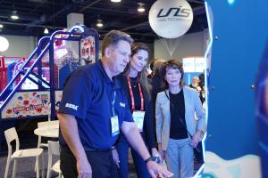 Attendees at Amusement Expo International were intently engaged with new games on the 2022 tradeshow floor.