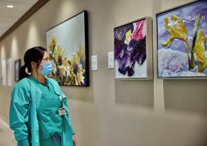 Nurse views glass paintings in A Garden of Gratitude art exhibition