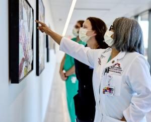 Hospital colleagues view glass paintings from a Garden of Gratitude leading to the Trauma Center