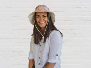 Model in Bush Berry Ecru Bucket Hat - Dreamtime artwork by Australian Aboriginal Artist, Marlene Doolan.  Marlene is  an established artist from Northern Territory, Australia and her artworks are widely valued.