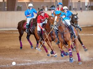 players on horses competing in girls high school arena polo match
