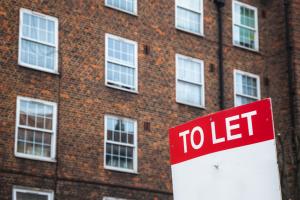 To Let sign with council housing flats at Rockingham estate in the background around Elephant and Castle area in south London
