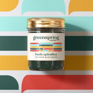 A glass jar containing Greenspring Farms fresh sprirulina