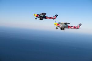 Two Red Bull planes flying over the sky