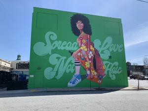 Atlanta street art mural of confident Black woman with message Spread Love, Not Hate