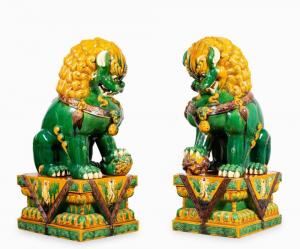 Monumental pair of Chinese Sancai glaze ceramic seated Buddhist lion figures on stands, 57 inches tall ($5,938).