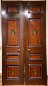 Pair of Edwardian mahogany architectural doors with hand-painted vignettes, 96 inches by 25 inches (est. $1,000-$2,000).