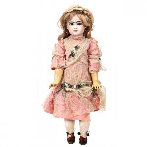 French bisque head doll marked Tete Jumeau, 24 inches tall, with pierced ears, a closed mouth, sleep eyes, a jointed wood body and a pink dress.