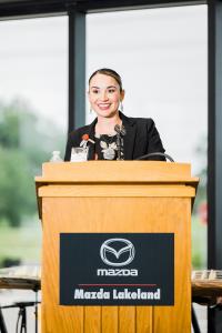 Sophia Justiz proudly welcomes customers and guests to the grand opening of Mazda Lakeland, a member of the Holler-Classic Family of automobile dealerships.