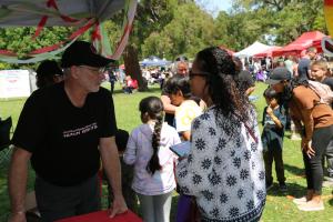 Jim Van Hill, Executive Director of CCHR Sacramento, talking to a parent about the sometimes life-threatening effects of psychotropic drugs.