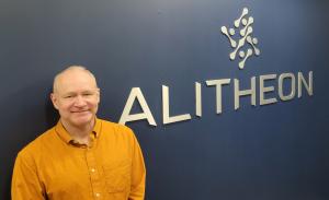 Nick Kline, VP Engineering, Alitheon standing in front of the company sign in its Bellevue offices