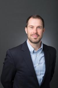 White male in a blue suit and tie, Eric Shaw. named Chief Growth Officer.