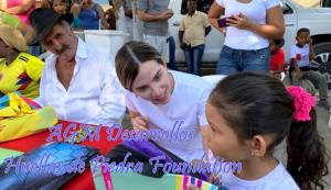 Residents of Cartagena at a table, adults focus on a little girl and anxiously await her response