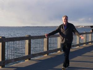 Rick Steves strolls the elevated boardwalk on the bay in Bellingham, WA