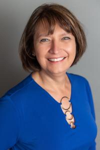 a smiling headshot of senior fellow Denise Juneau