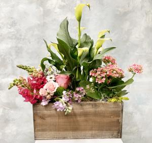 Large spring floral arrangement in wooden planter
