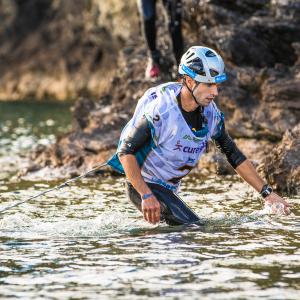 Pasokin founder and adventure racer Marco Amselem crossing a river at a GODZone adventure race in New Zealand