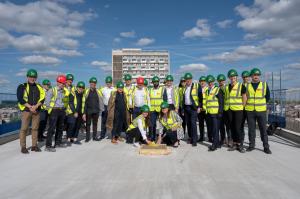 At the Topping Out Ceremony, from left to right: Stephanie Michele, Ruby Hotels and Jo Allen, Frogmore with colleagues and representatives from the Professional Team and hotel building Contractor Gilbert-Ash.